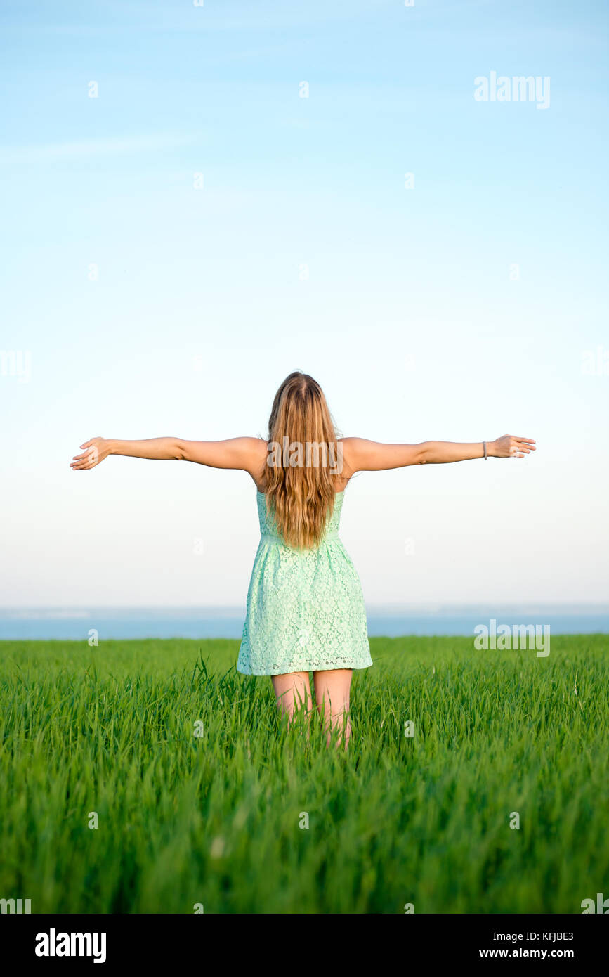 Happiness woman stay outdoor under sunlight of sunset Stock Photo