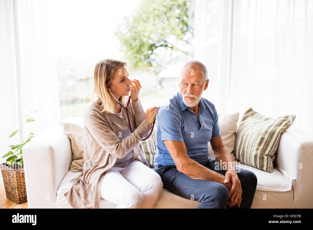 Health visitor and a senior man during home visit Stock Photo Alamy