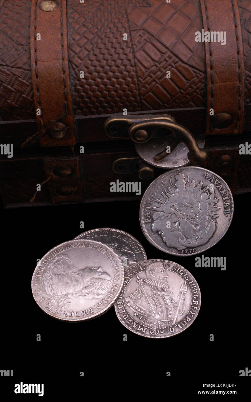 Part of vintage wooden chest with old silver coins of 16-18th centuries Stock Photo