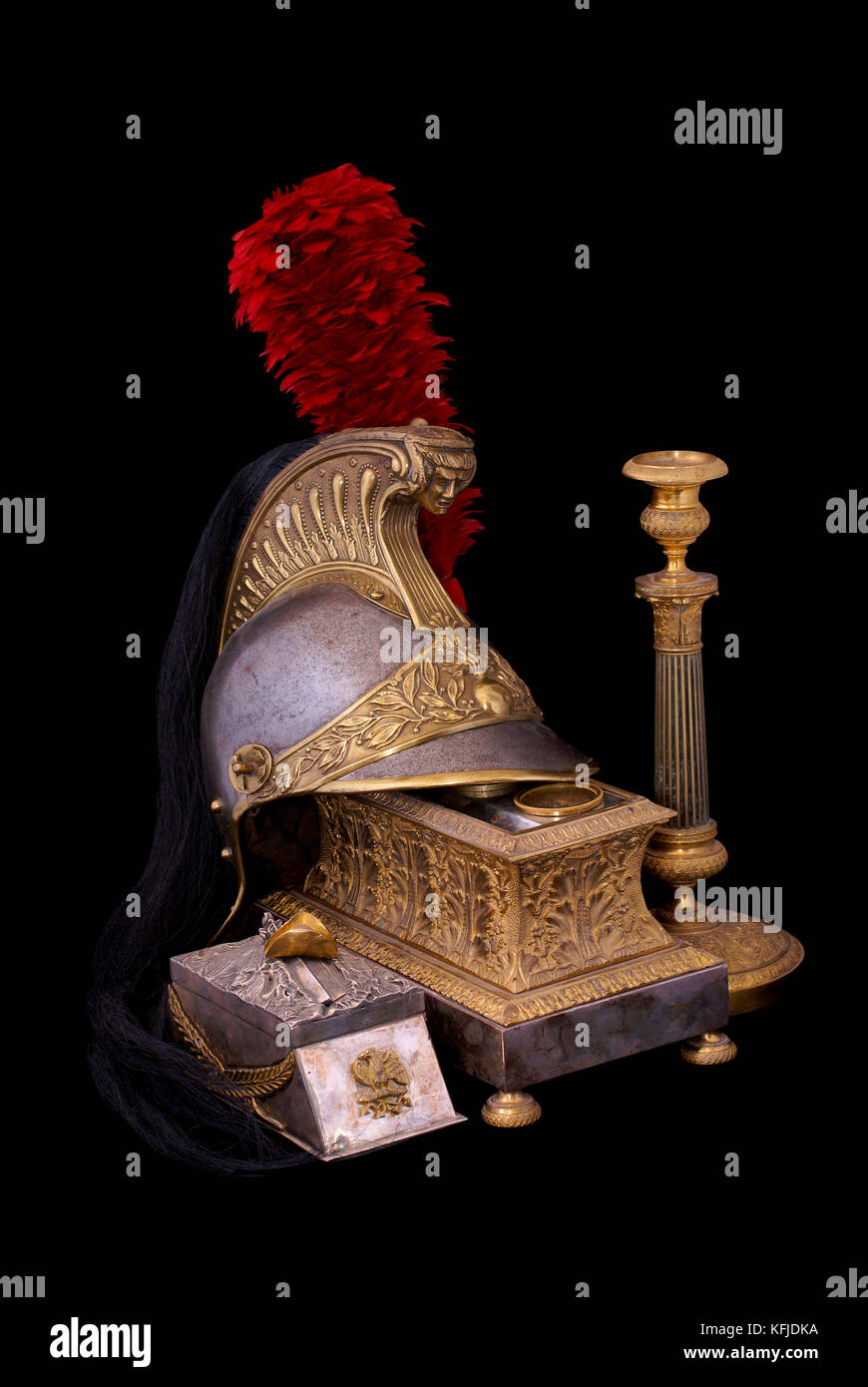Composition with French cuirassier helmet (1836), bronze inkstand with gilding (1830) and old bronze candlestick (candleholder). Path on dark backgrou Stock Photo