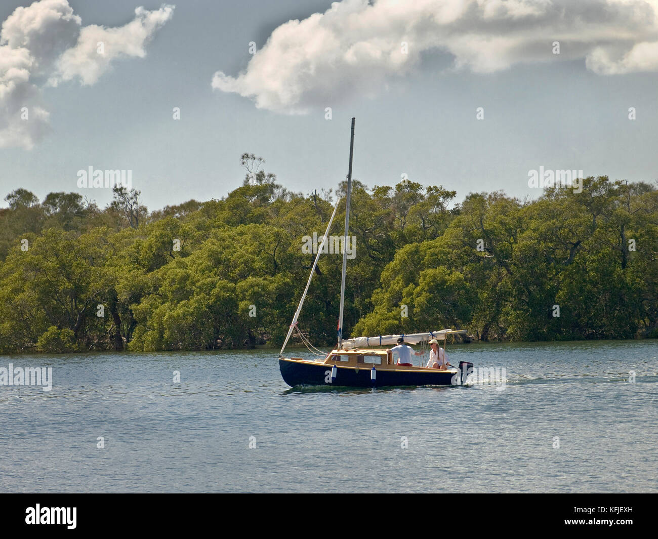 Australia: Sailing craft motoring along Tilligerry Creek, Lemon Tree Passage, NSW Stock Photo