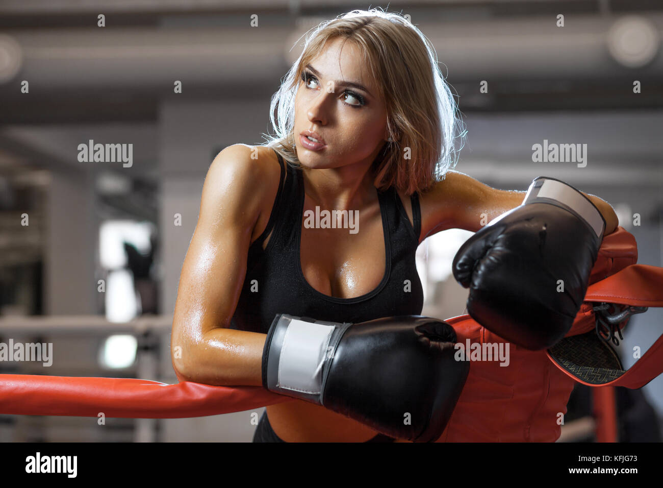 Young pretty boxer woman standing on ring Stock Photo - Alamy
