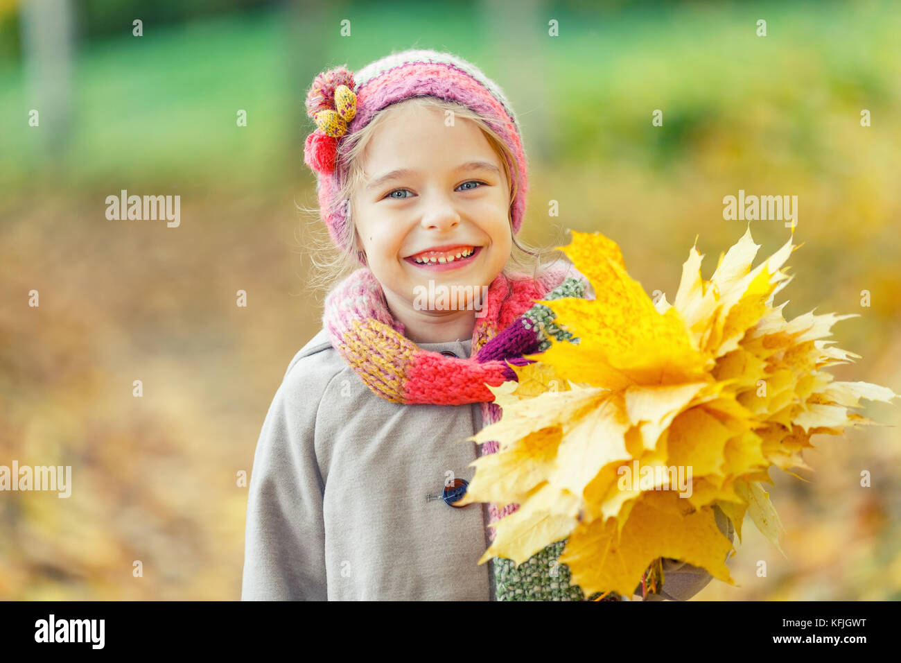 Happy little girl with autumn leaves in the park Stock Photo - Alamy