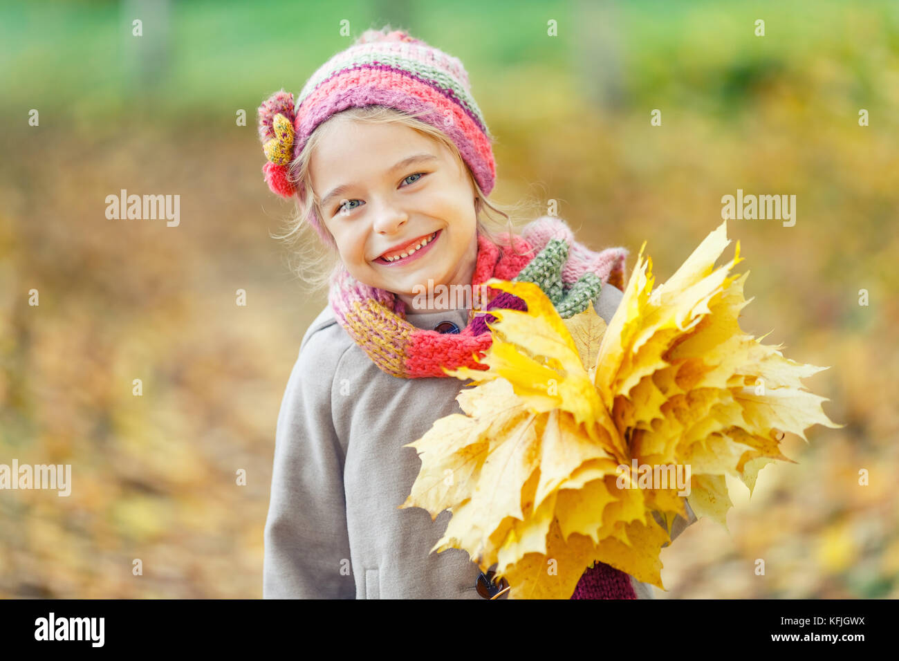 Happy little girl with autumn leaves in the park Stock Photo - Alamy