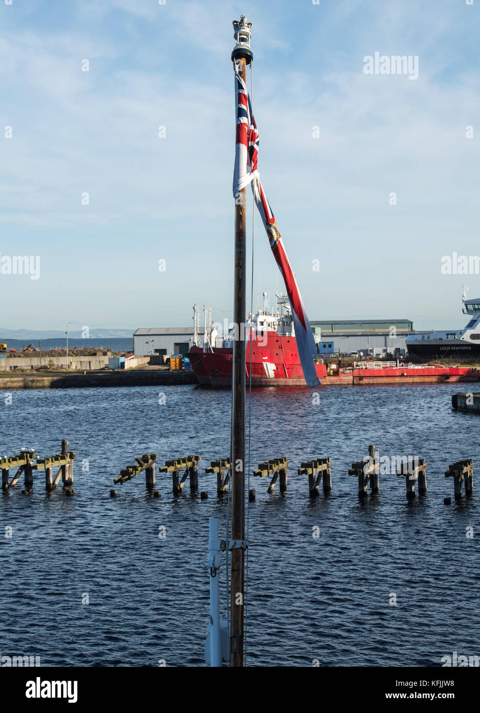 Edinburgh, Scotland, The Royal Yacht Britannia at Ocean Terminal, Leith, Edinburgh, The flagpole looking across Leith docks Stock Photo