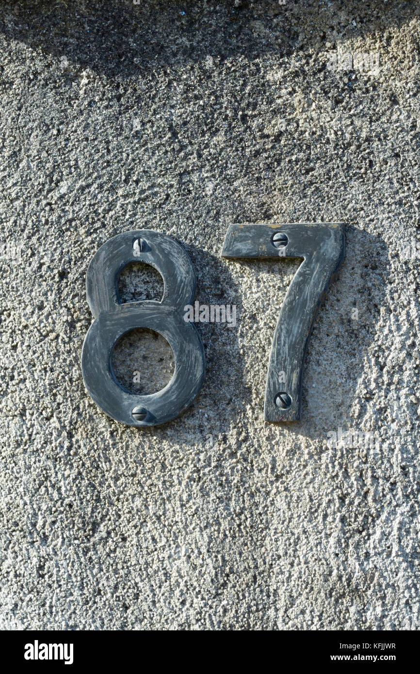 House number 87 sign on wall Stock Photo - Alamy