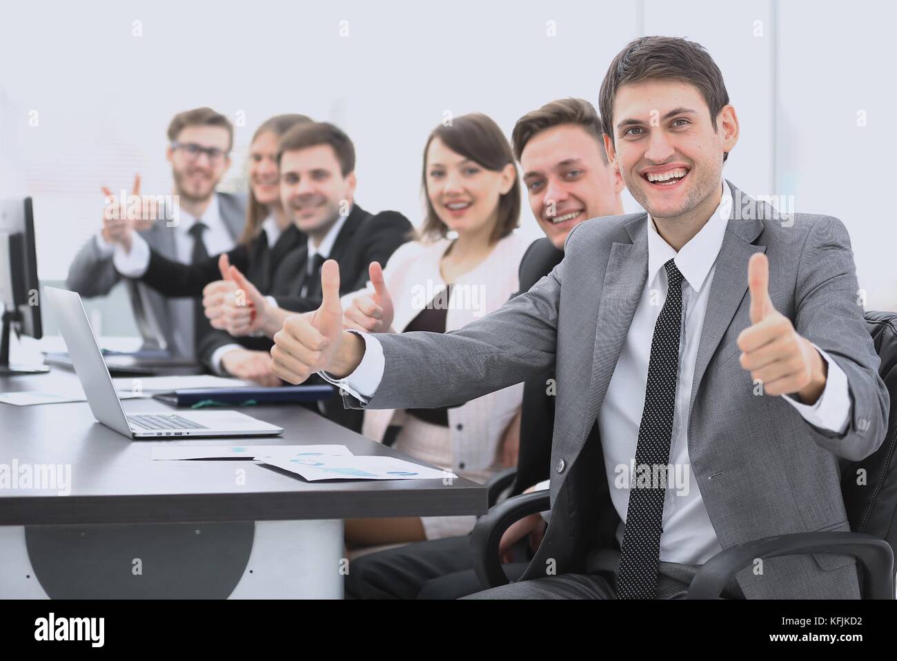 successful business team showing thumbs up Stock Photo - Alamy