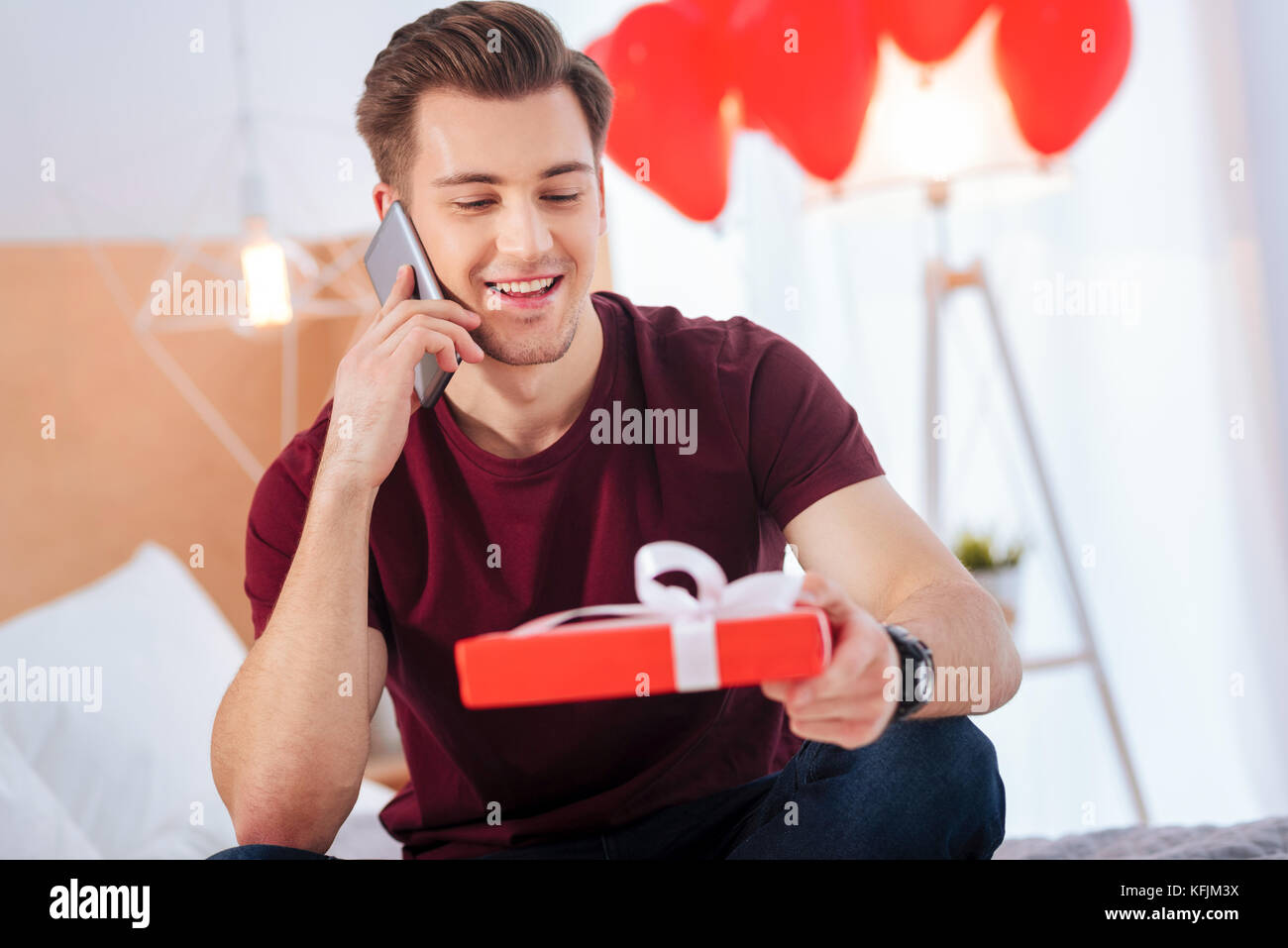 Loving guy calling his girlfriend at home Stock Photo