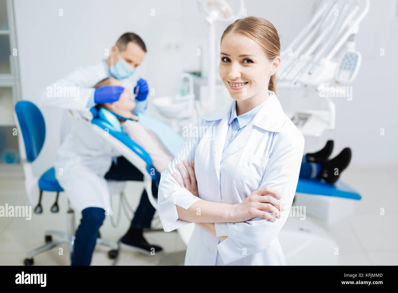 Cheerful beautiful dentist standing cross handed Stock Photo Alamy