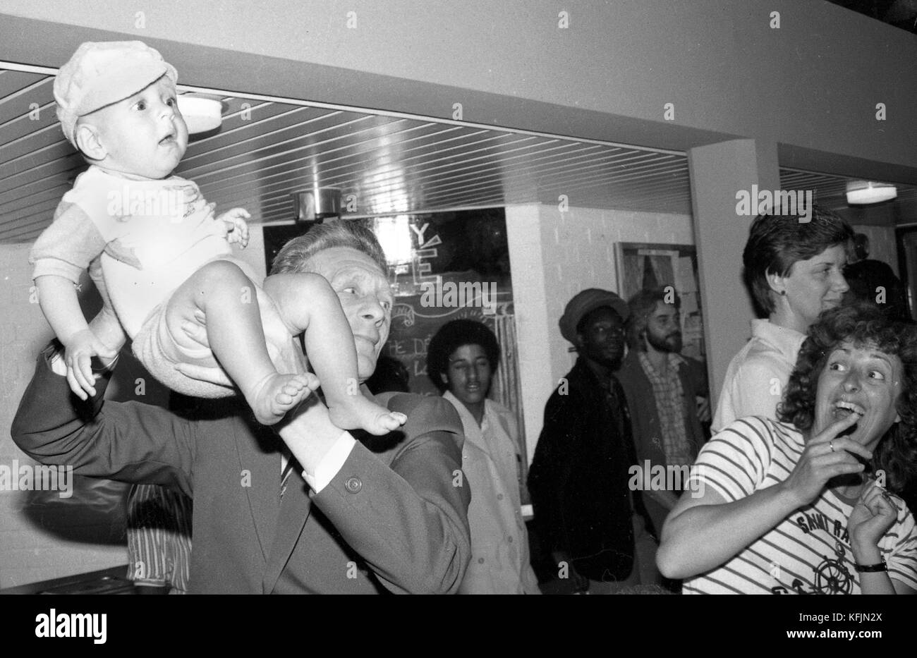 18 May 1982, Deptford. Princess Diana on a Royal visit to open the Albany Arts Centre for the community of Deptford.  A visitor holds aloft a baby to get Diana's attention.  Photo by Tony Henshaw *** Local Caption *** Copyright Tony Henshaw Stock Photo