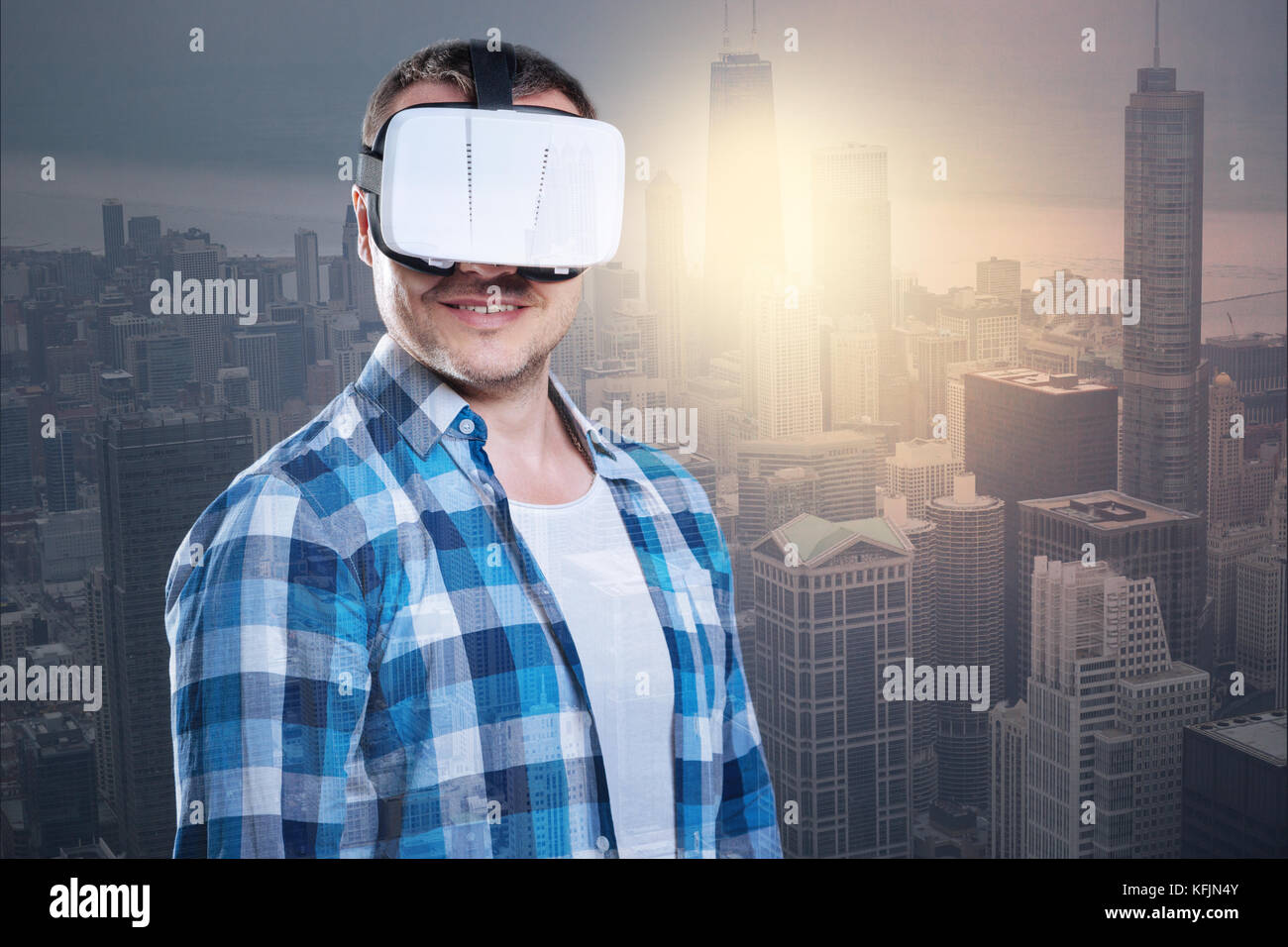 Smiling positive man wearing virtual reality glasses Stock Photo - Alamy