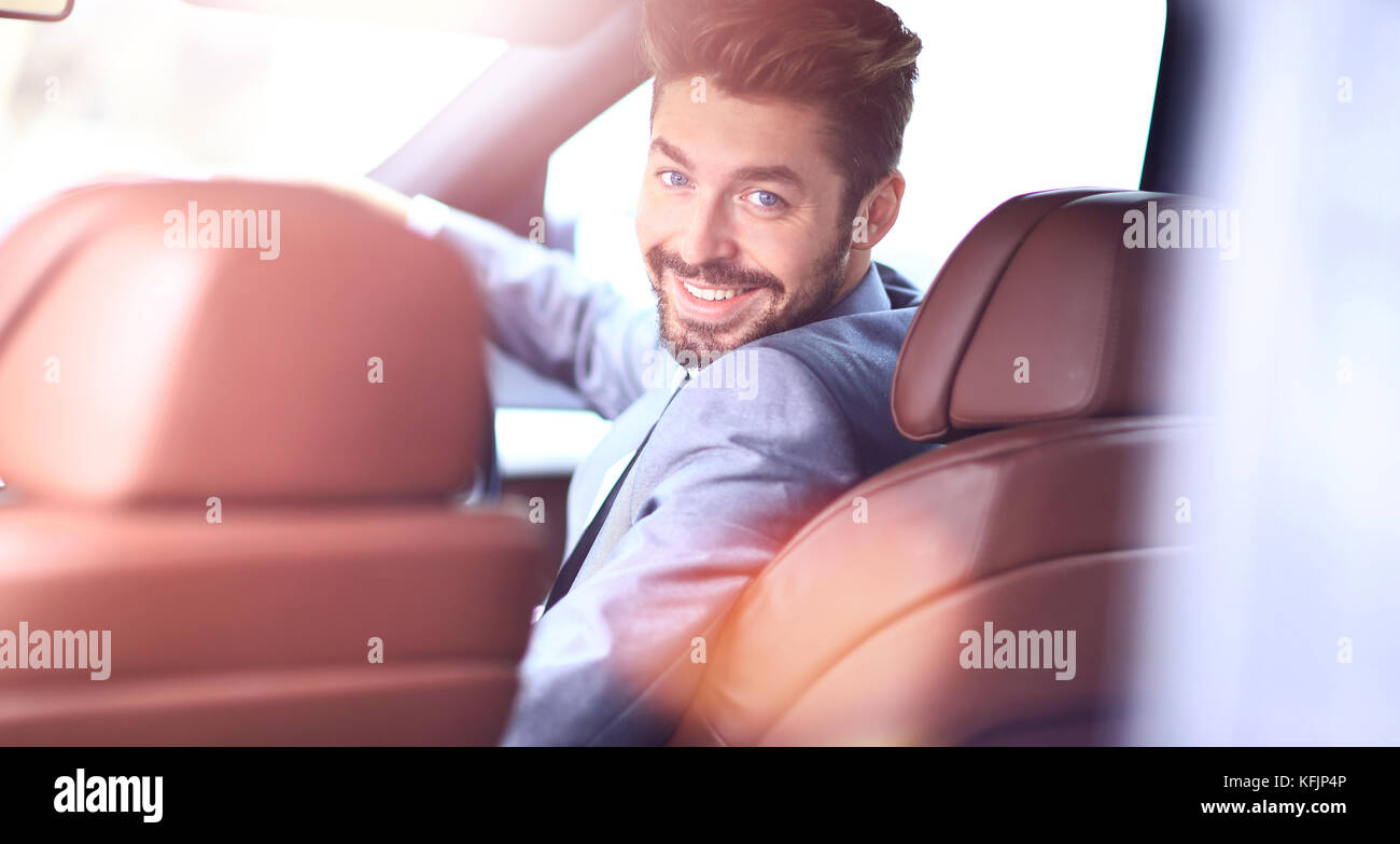 Portrait of an handsome smiling business man driving his car Stock ...