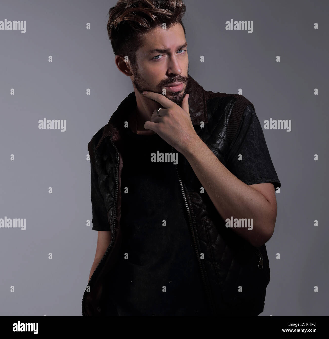 Portrait of a pensive handsome man over gray background Stock Photo - Alamy