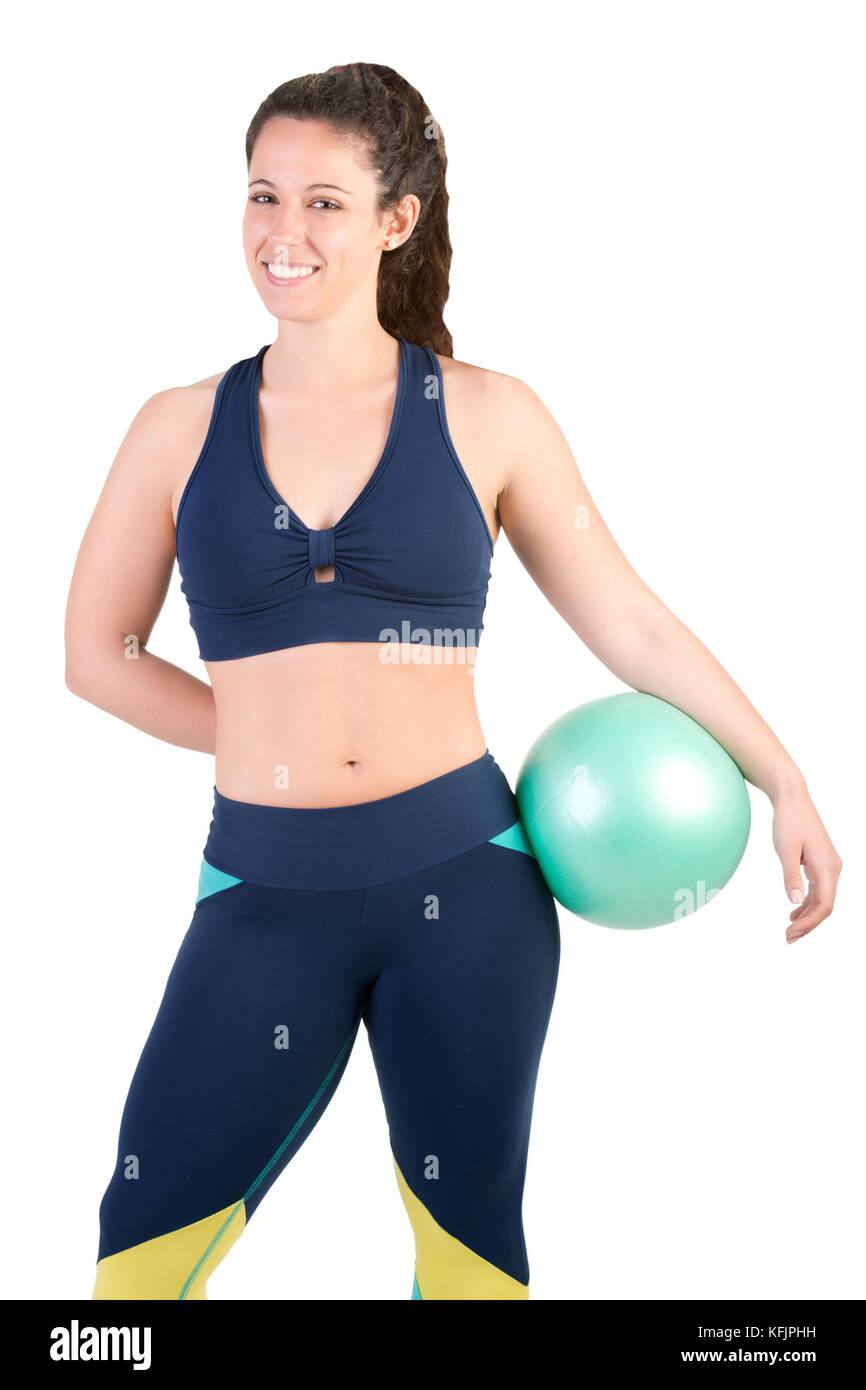 Fit woman standing and holding a pilates ball, isolated in white Stock Photo