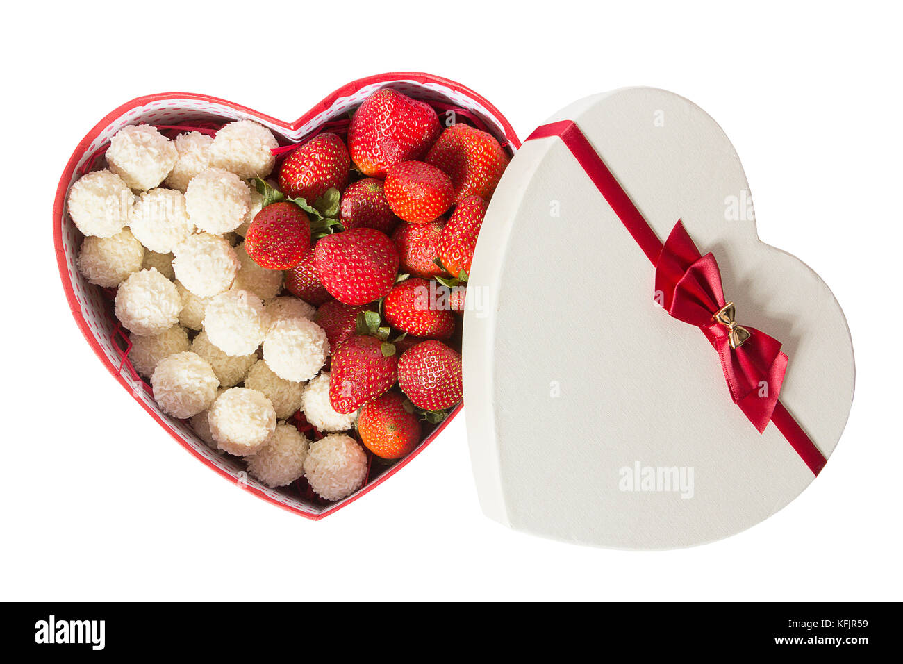 Gift box in the form of a heart on the Valentine's Day is isolated on white background. Box in the form of a heart with strawberries and sweets. Sweet gift. Stock Photo