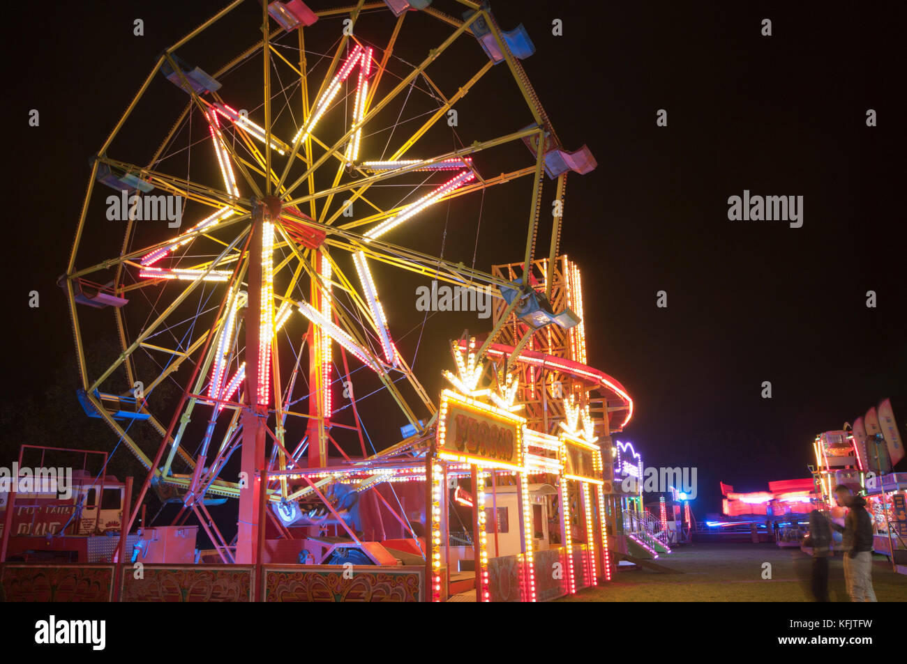 Travelling Funfair At Night With Bright Lights Fairground with brightly