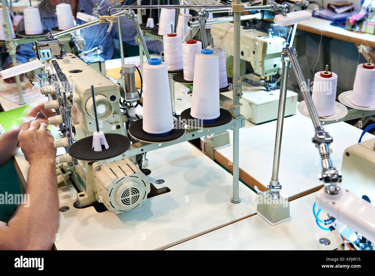 Sewing with threads and electric sewing machines Stock Photo Alamy