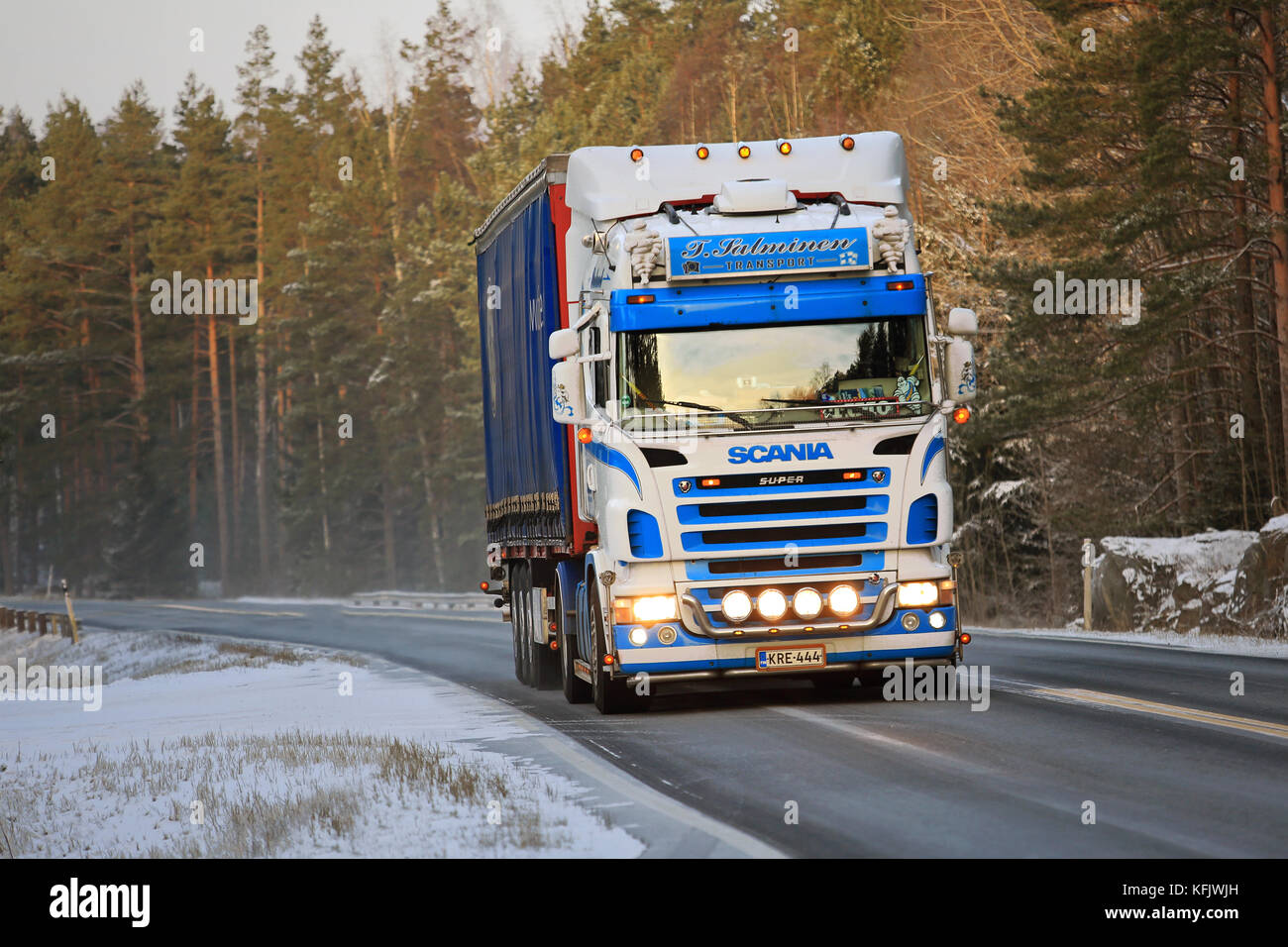 SALO, FINLAND - JANUARY 9, 2016: Colorful Scania semi truck on the road in wintery South of Finland. There is no common legislation in the EU concerni Stock Photo
