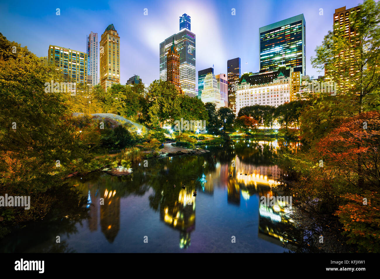 The Pond by night, as viewed from Gapstow Bridge in Central Park, New York City Stock Photo
