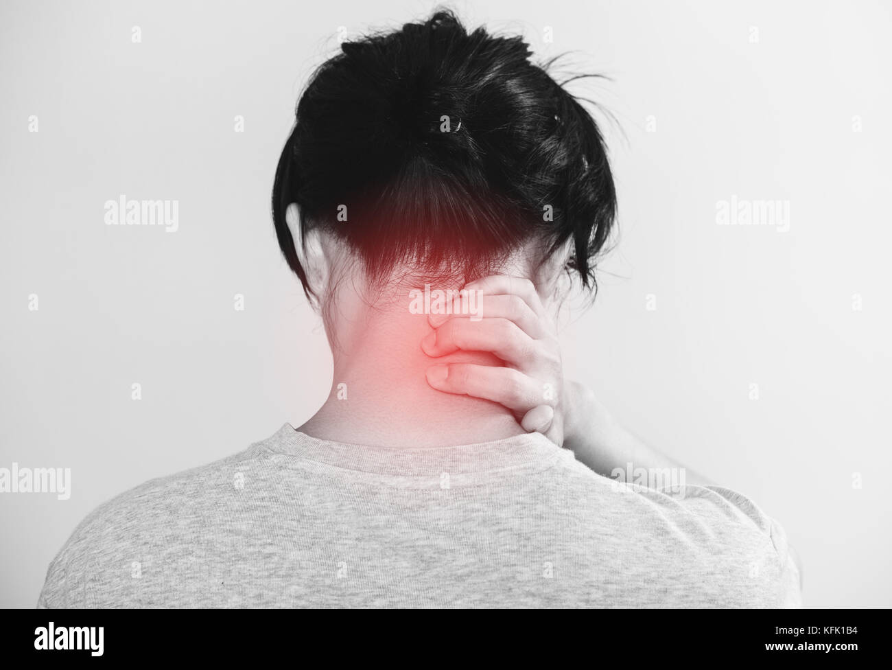 a man touching his neck with red highlight of back neck pain concept, on white background Stock Photo