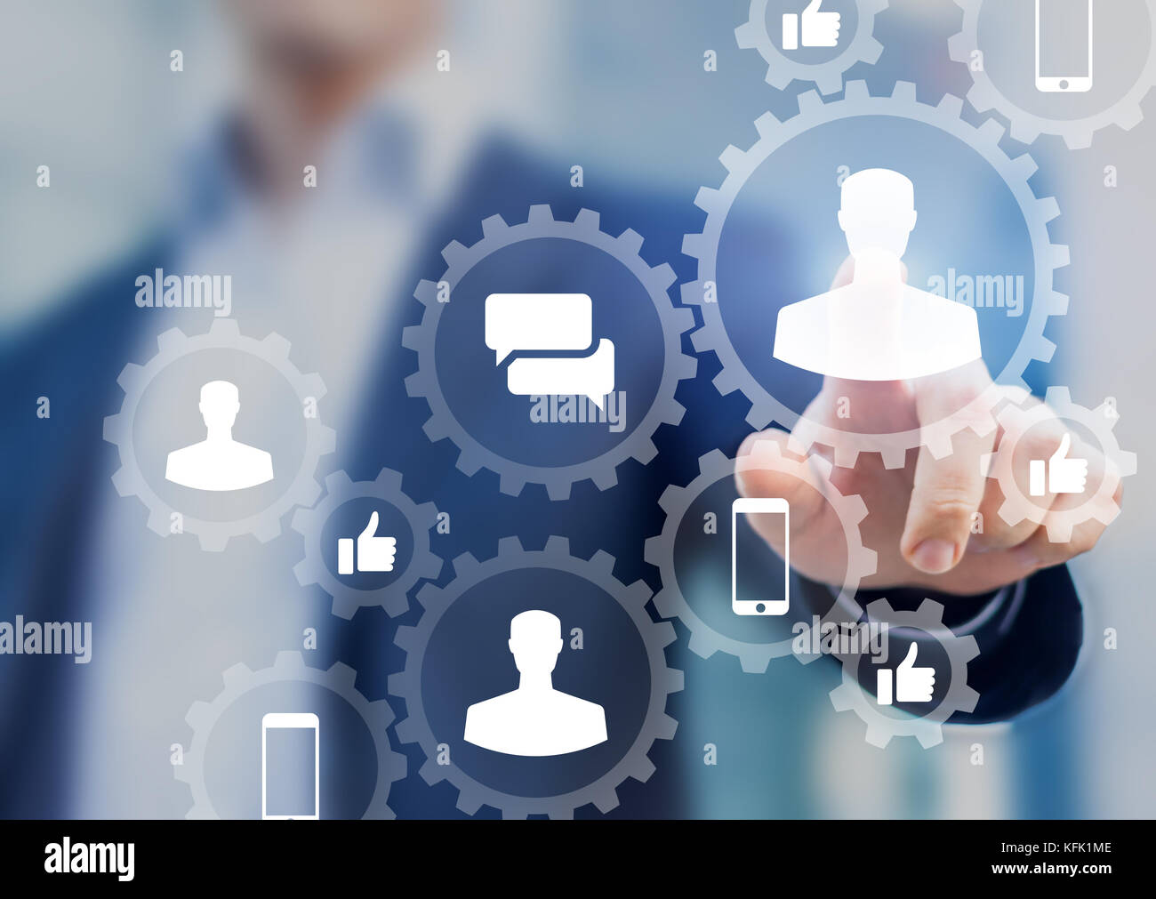 Social media digital marketing concept with icons of people profile, like, comment and smartphone inside connected gears network, businessman in backg Stock Photo