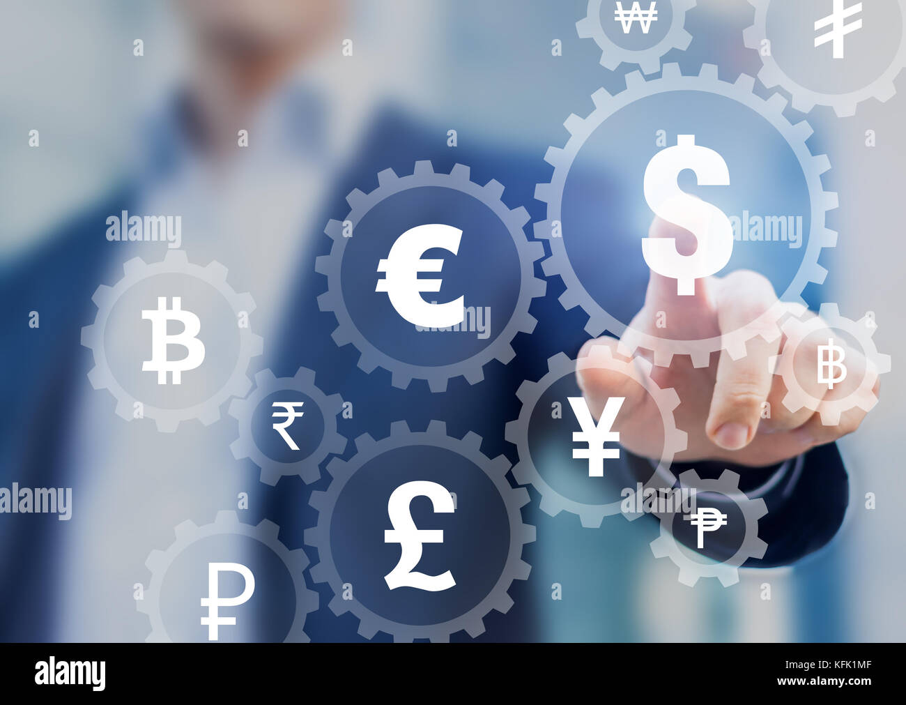 Foreign exchange trading concept with currency symbols inside connected gears to show connection between money, businessman in background Stock Photo