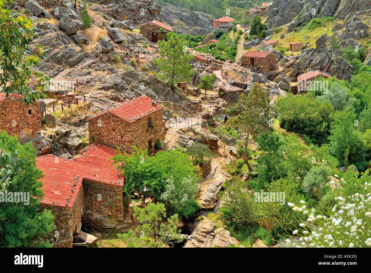 View of granite rock valley with restored historic water mills of schist stone Stock Photo