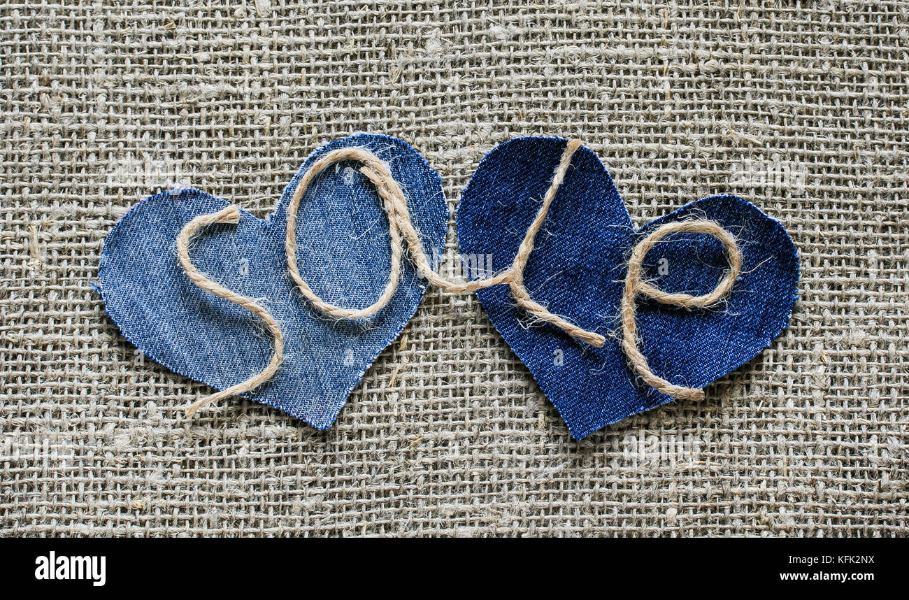 stylish inscription from sale of twine in my hand on two denim senecah on the background fabric burlap for window dressing Stock Photo