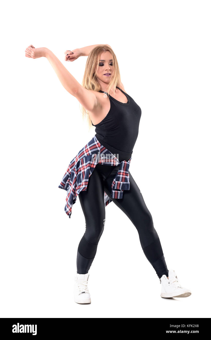 Energetic jazz dance female dance instructor swinging arms behind head with closed eyes. Full body length portrait isolated on white background. Stock Photo