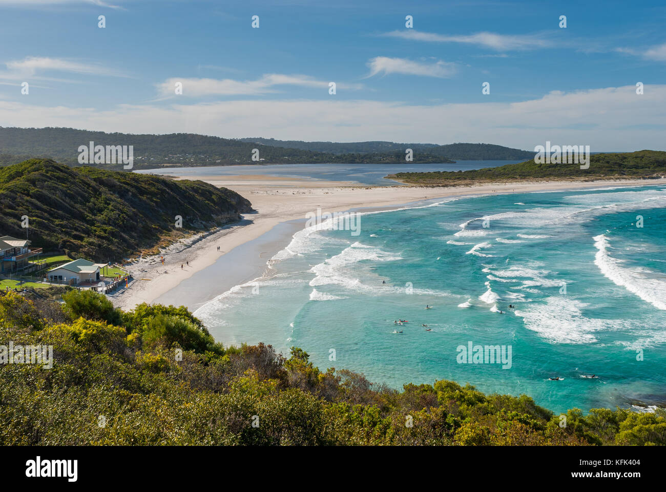 Surfers ride the waves rthat oll into the protected beach at Ocean Beach in Denmark, along the south coast of Western Australia. Stock Photo