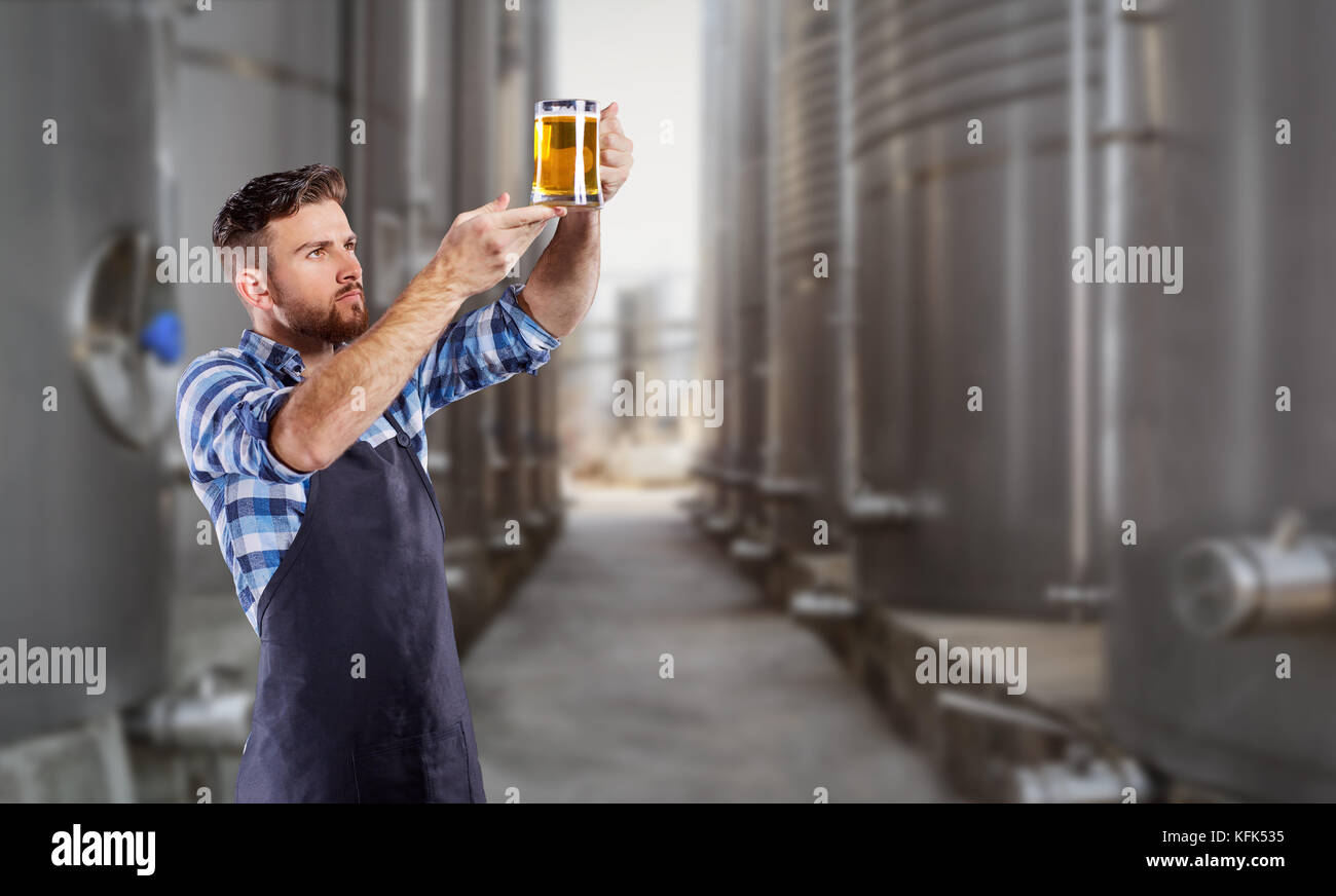 Brewer man with a glass of beer in his hand Stock Photo