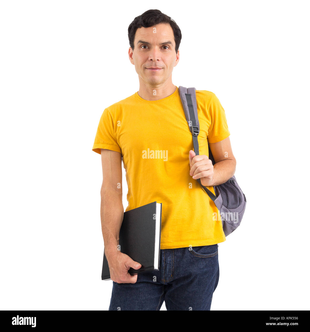 Student going to class. College. Proof. Entrance exam. Studies. He is wearing a yellow jersey. Isolated on white background. He is holding a notebook  Stock Photo