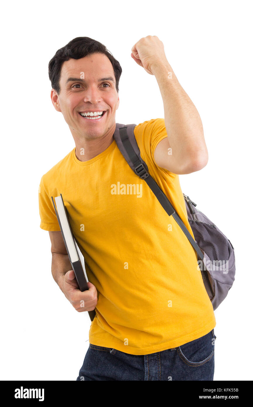 Student celebrating. College. exams Entrance exam. Studies. Conquest. He is wearing a yellow jersey. Isolated on white background. He is holding a not Stock Photo