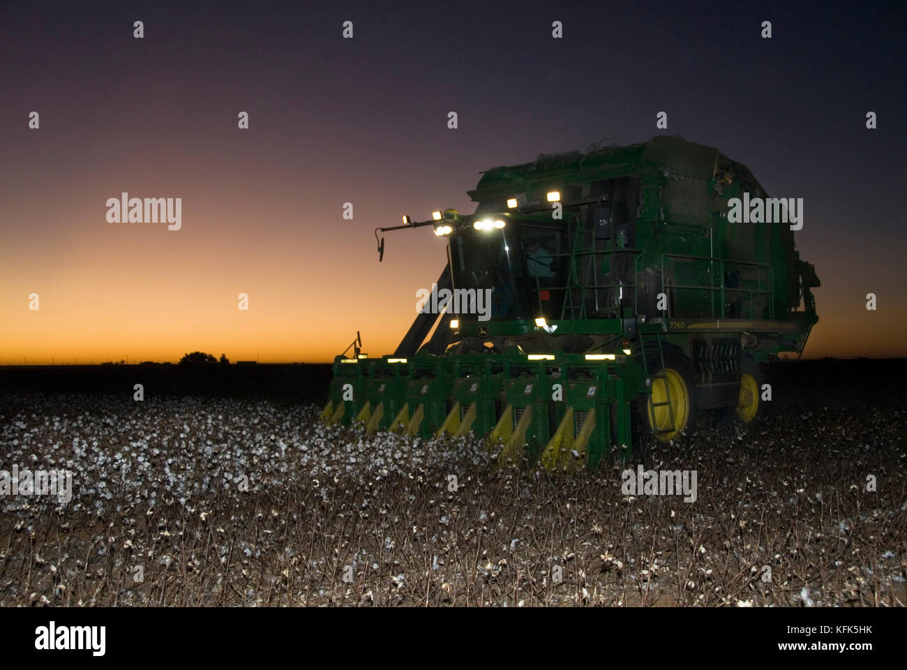 NEW JOHN DEERE 6 ROW COTTON PICKER AT NIGHT THAT MAKES ROUND MODULES