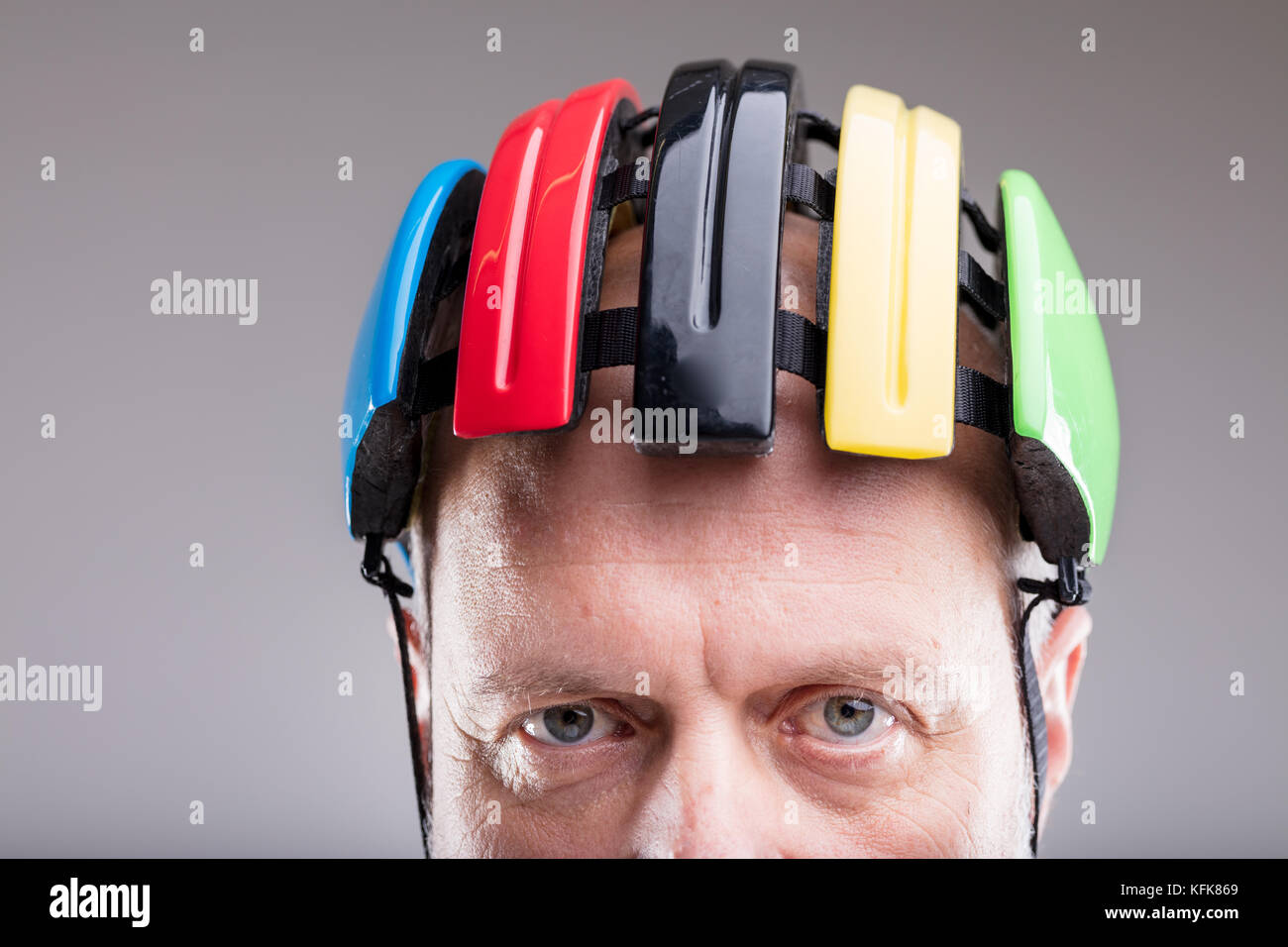 old man with an head protection helmet to be safe when he ride his bicicle - closeup of the face Stock Photo