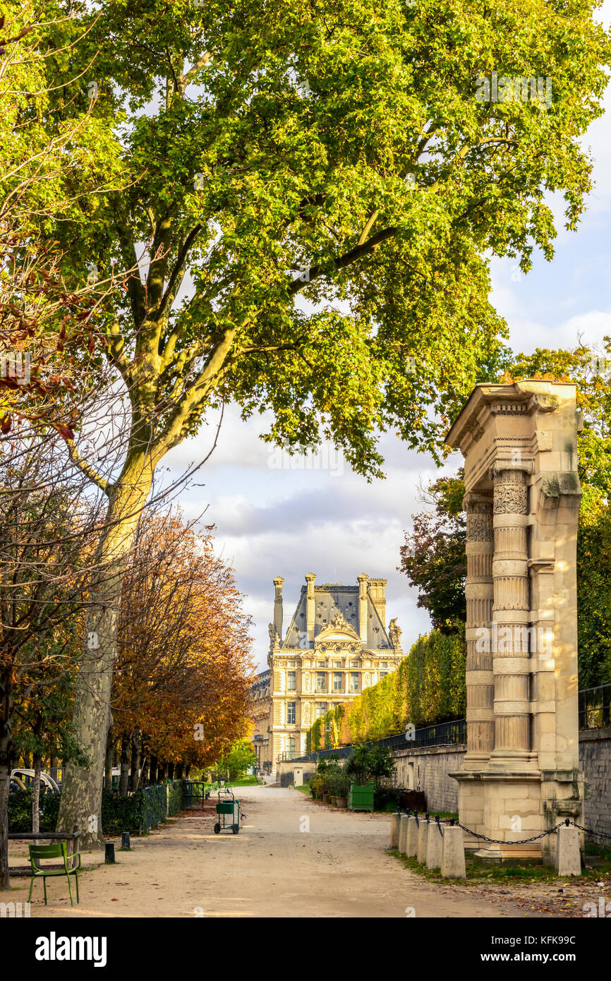 View of the Tuileries garden in Paris at the end of an autumn day with a remnant arcade of the Tuileries palace in the foreground and the Flore pavili Stock Photo