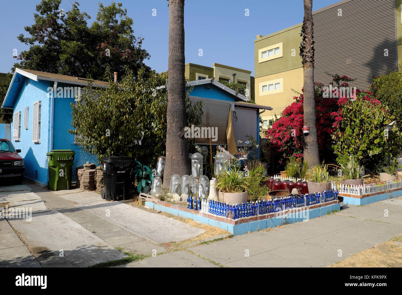House and front garden with fence made by recycling Budweiser beer bottles in Frogtown North East Los Angeles California USA  KATHY DEWITT Stock Photo