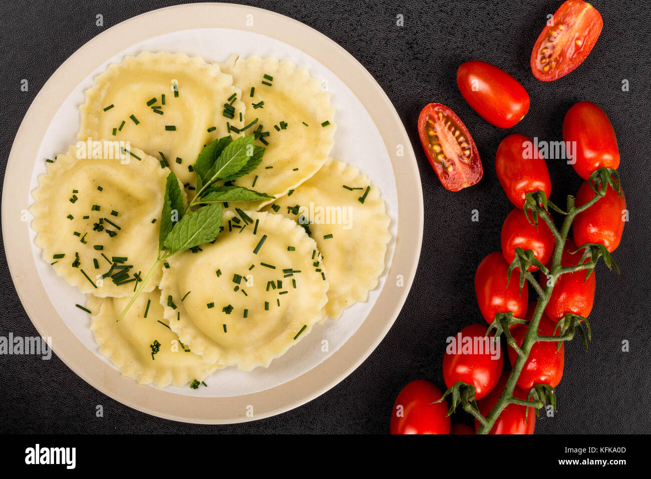 Italian Style Cappelletti With Parma Ham Ravioli Pasta Against a Black Background Stock Photo