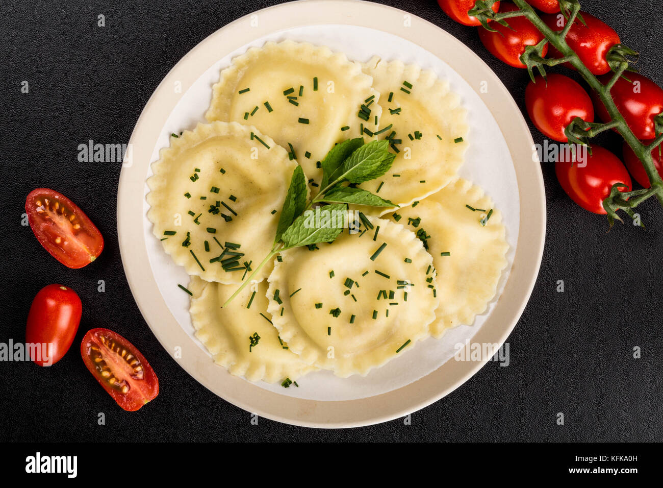 Italian Style Cappelletti With Parma Ham Ravioli Pasta Against a Black Background Stock Photo