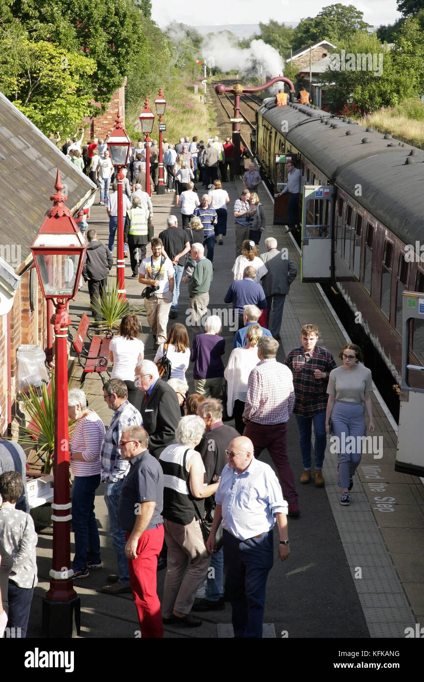 Passengers taking a break on Appleby station platform while travelling on 'The Dalesman' steam train, UK. Stock Photo