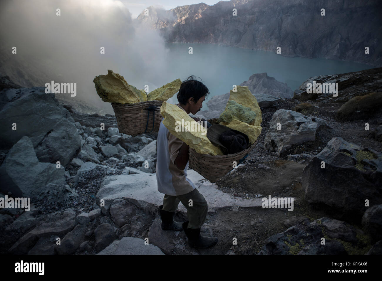 A sulfur miner working at the Kawah Ijen volcano in East Java ...