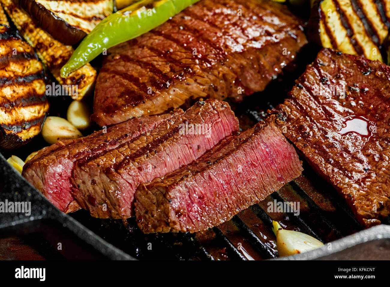 slicing delicious grilled meat with vegetable, close up Stock Photo