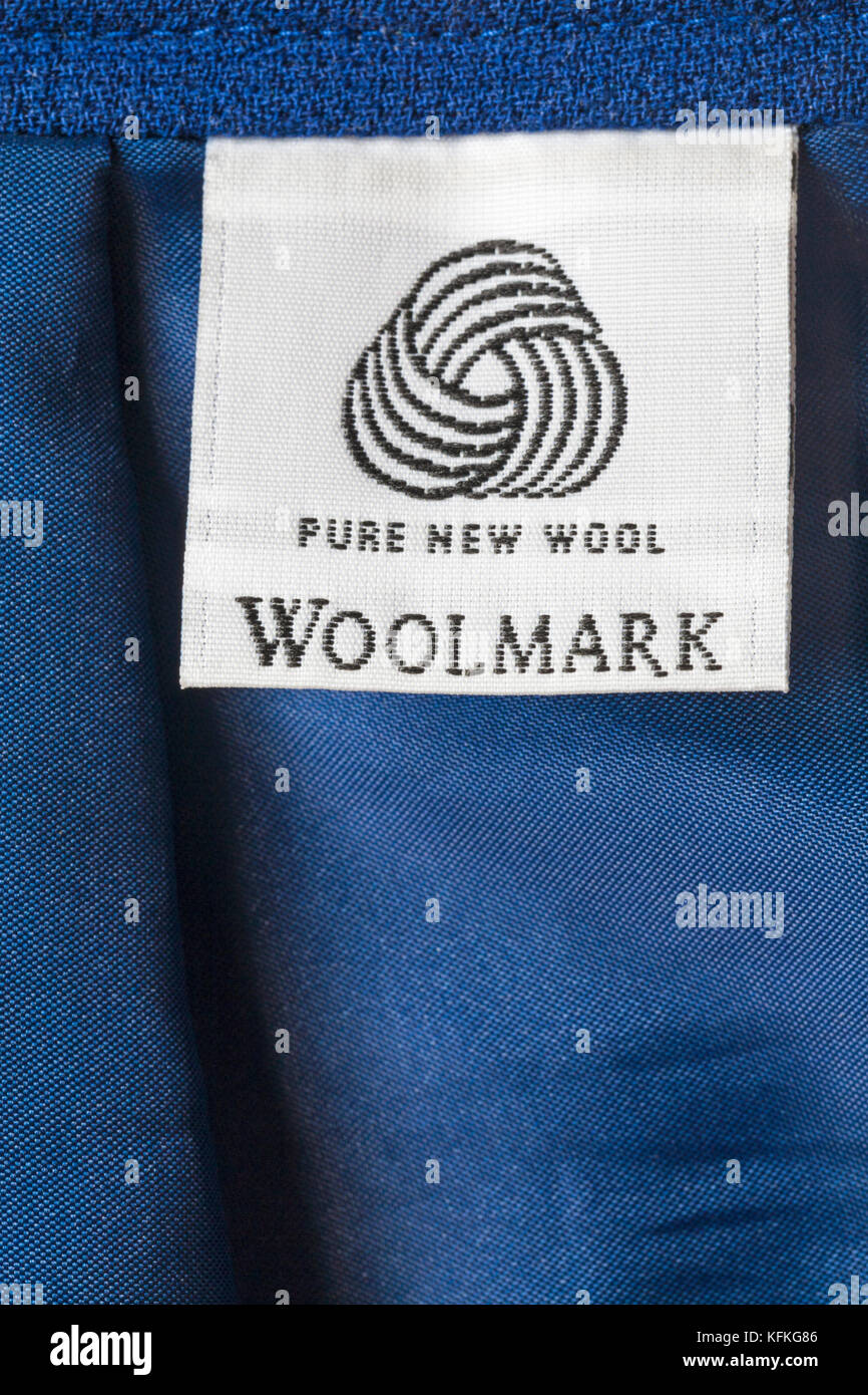 Pure New Wool logo Woolmark label in woman's blue suit Stock Photo