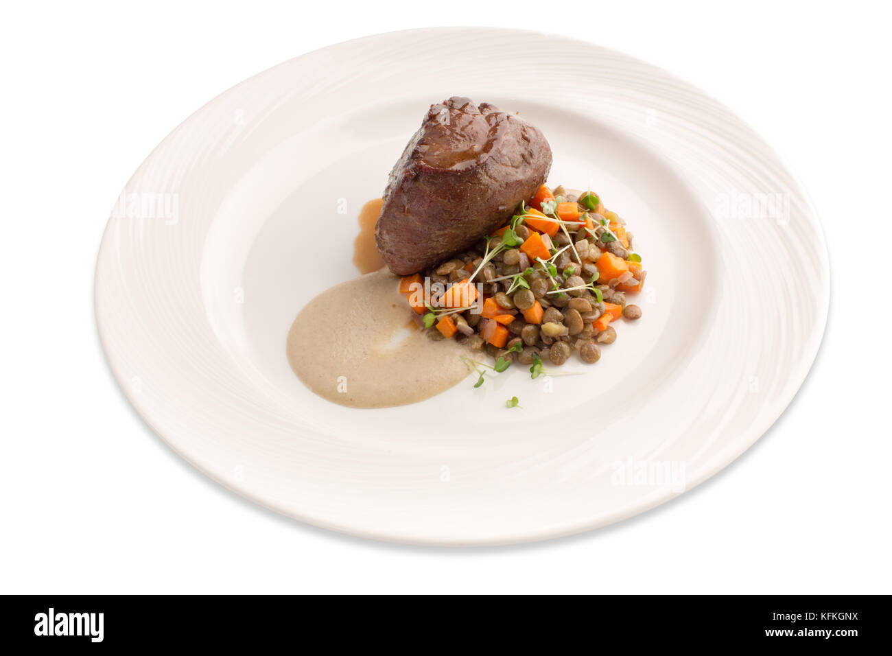 Fillet mignon lentil and sauce on plate isolate Stock Photo