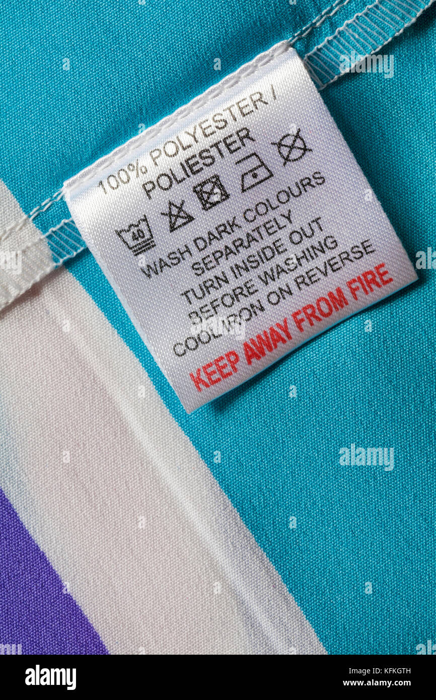 Keep away from fire 100% polyester label in woman's top with wash care instructions Stock Photo