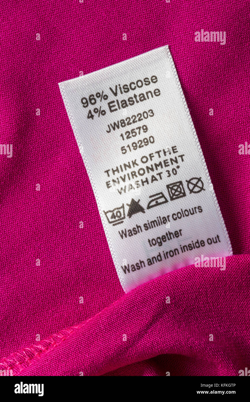 96% viscose 4% elastane label in woman's pink top with wash care ...