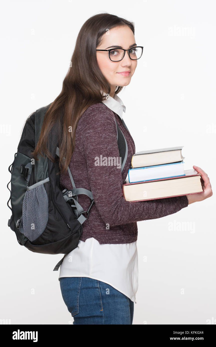Happy student life. Attractive cheerful young female student holding books, isolated on white background. Education concept Stock Photo