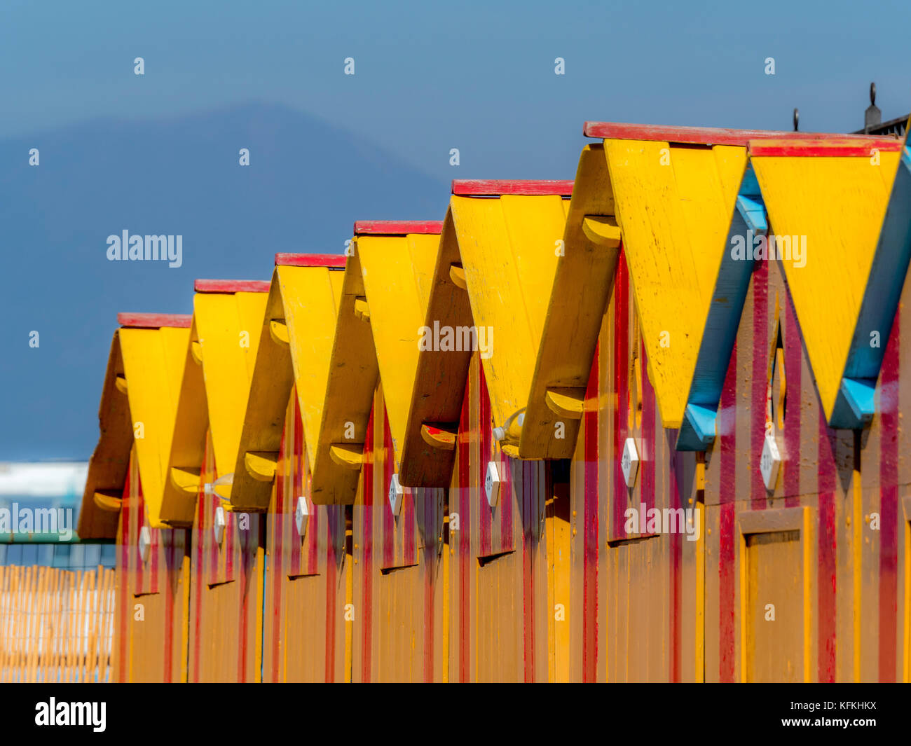 Yellow painted wooden bathing huts at Peter's Beach. A private beach in Sorrento. Italy Stock Photo