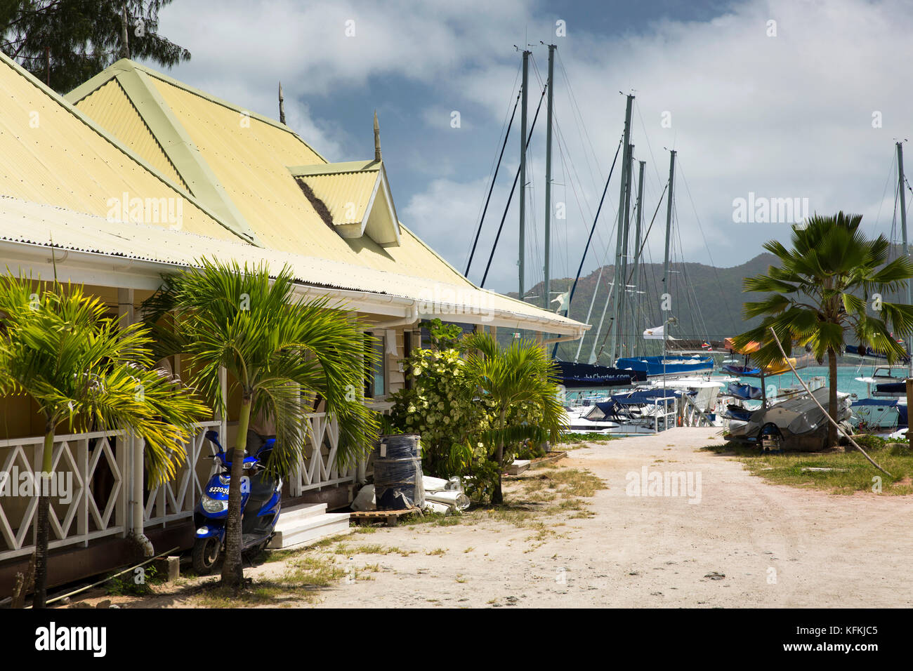 The Seychelles, Praslin, Baie St Anne, marina, office building beside yacht mooring Stock Photo