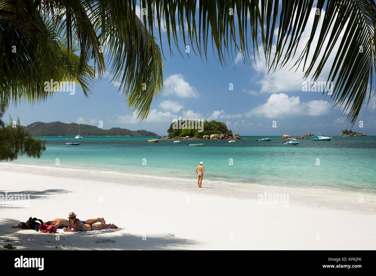 Sey270The Seychelles, Praslin, Anse Volbert, Cote d’Or, holidaymakers relaxing on idyllic beach Stock Photo